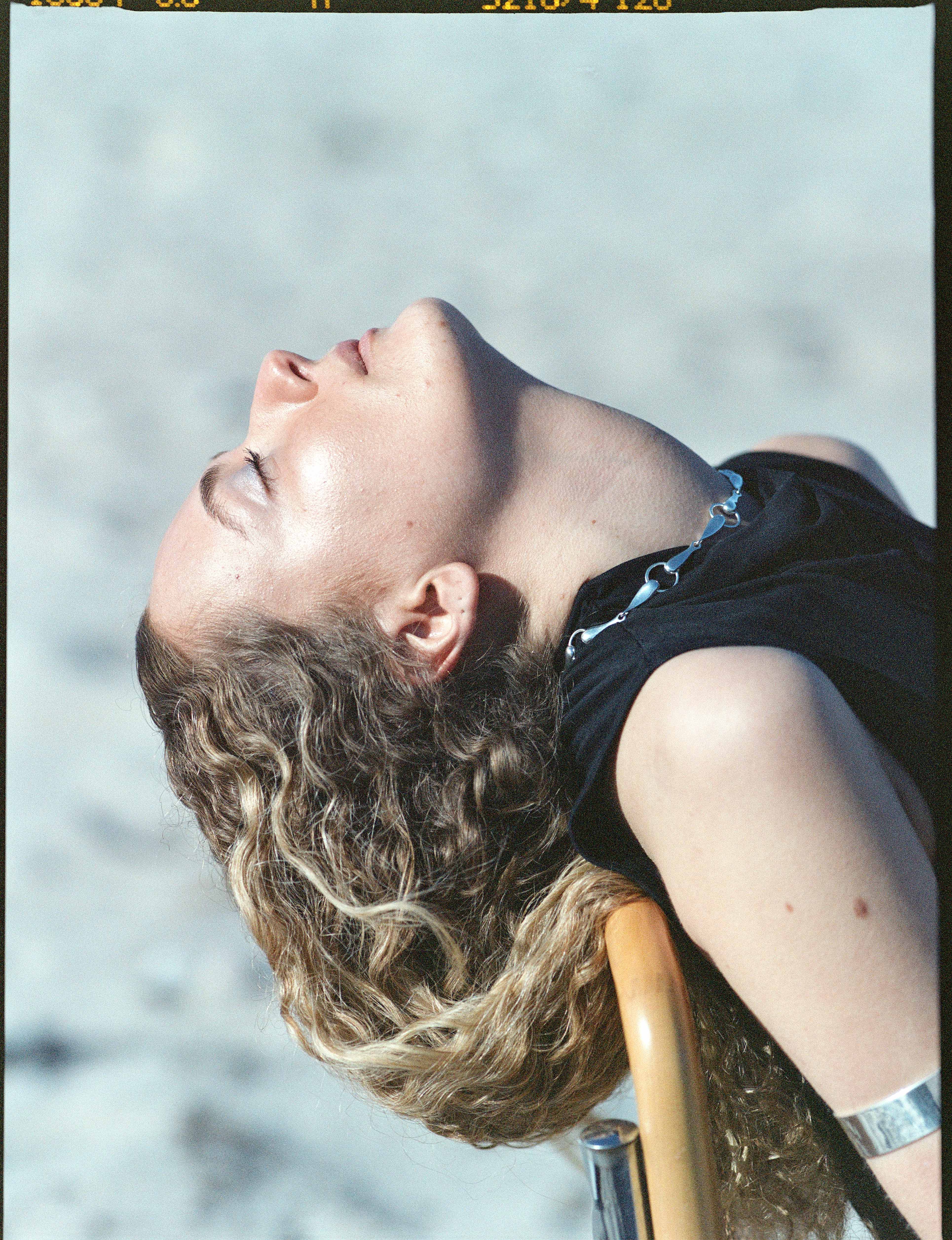 A woman wearing a SADRIA necklace